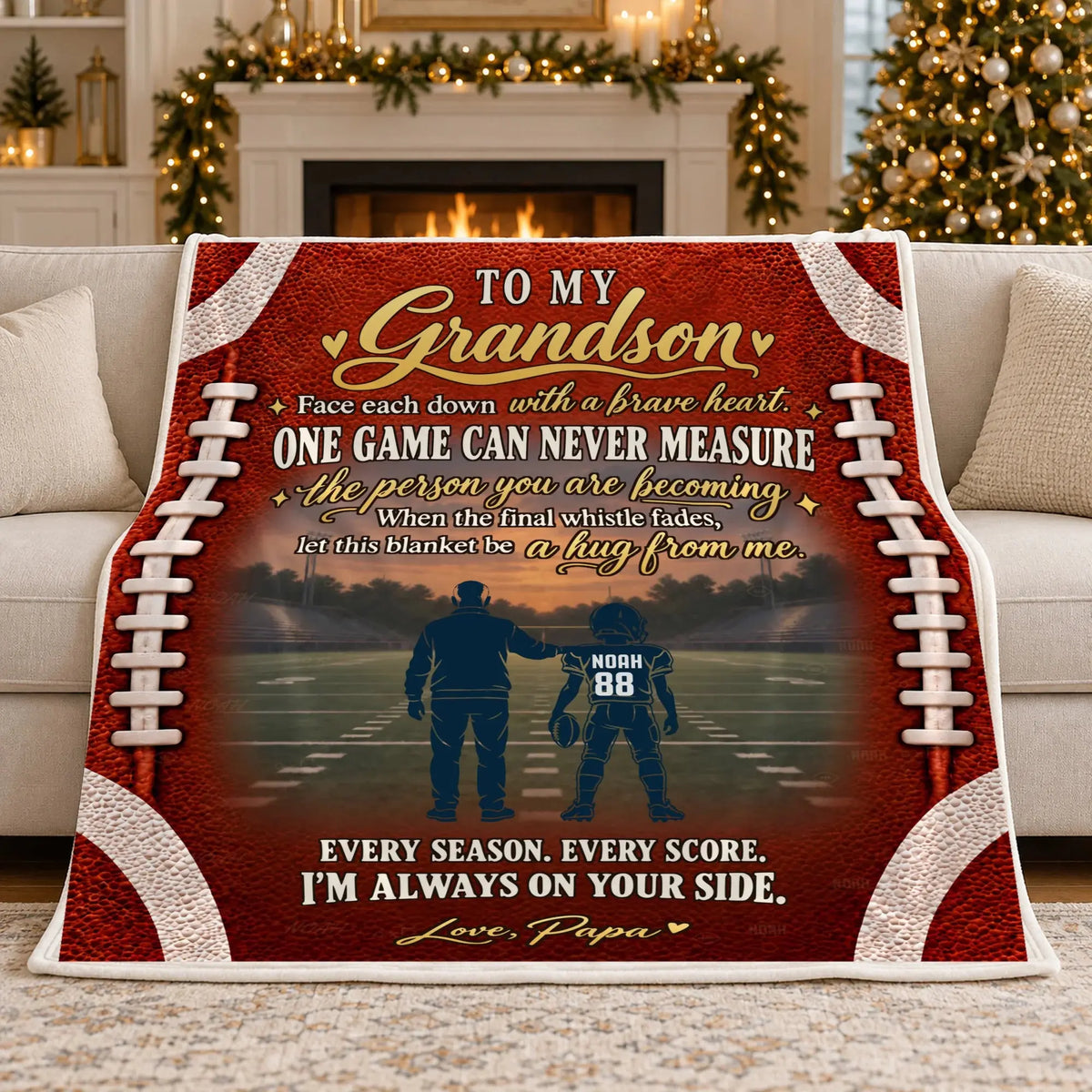 Personalized grandkid sports blanket draped on sofa in Christmas living room