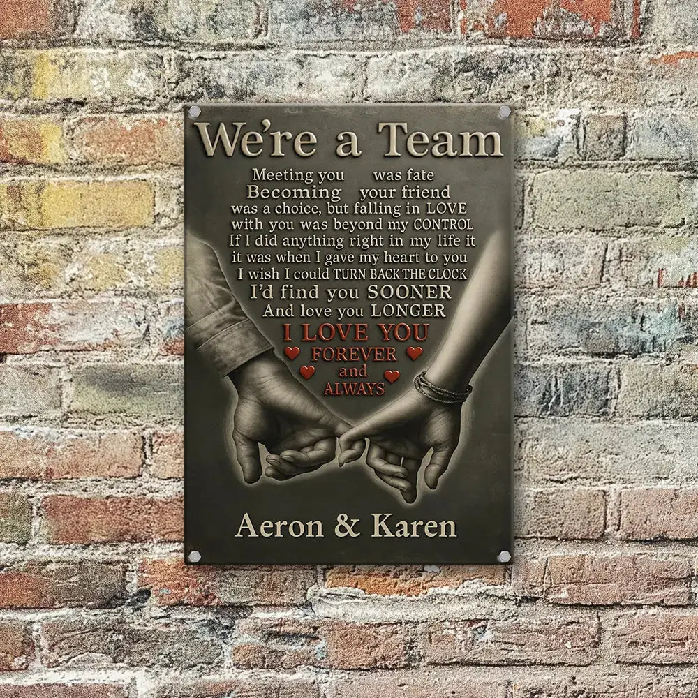 Decorative wall sign with hands holding text 'We're a Team' and personalized names 'Aeron & Karen' on a neutral background.