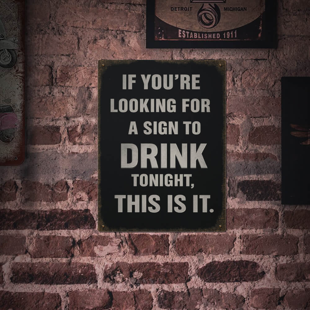 Brick wall with a sign reading 'If you're looking for a sign to drink tonight, this is it.'