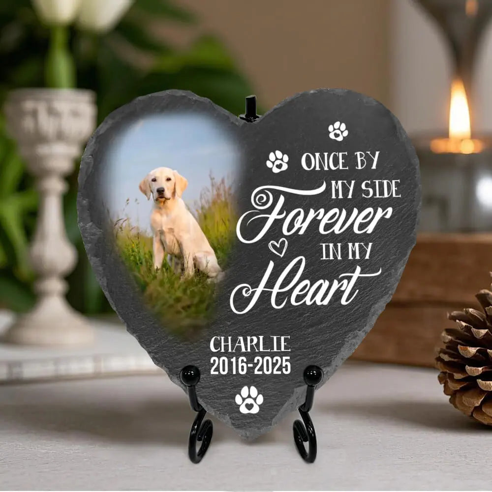 Heart-shaped slate plaque with a photo of a dog and text 'Once by my side, forever in my heart' on a stand.