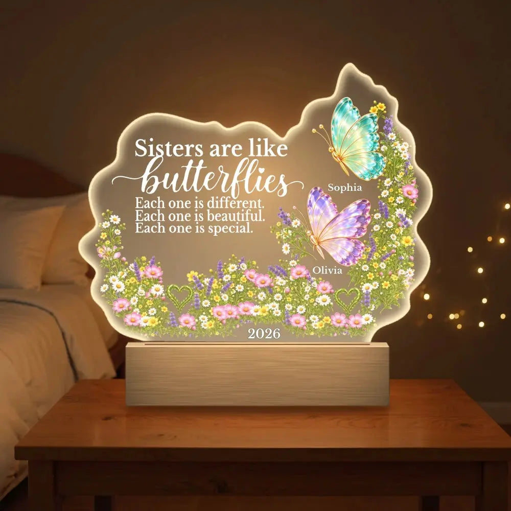 Custom sisters butterfly night light glowing on a bedside table