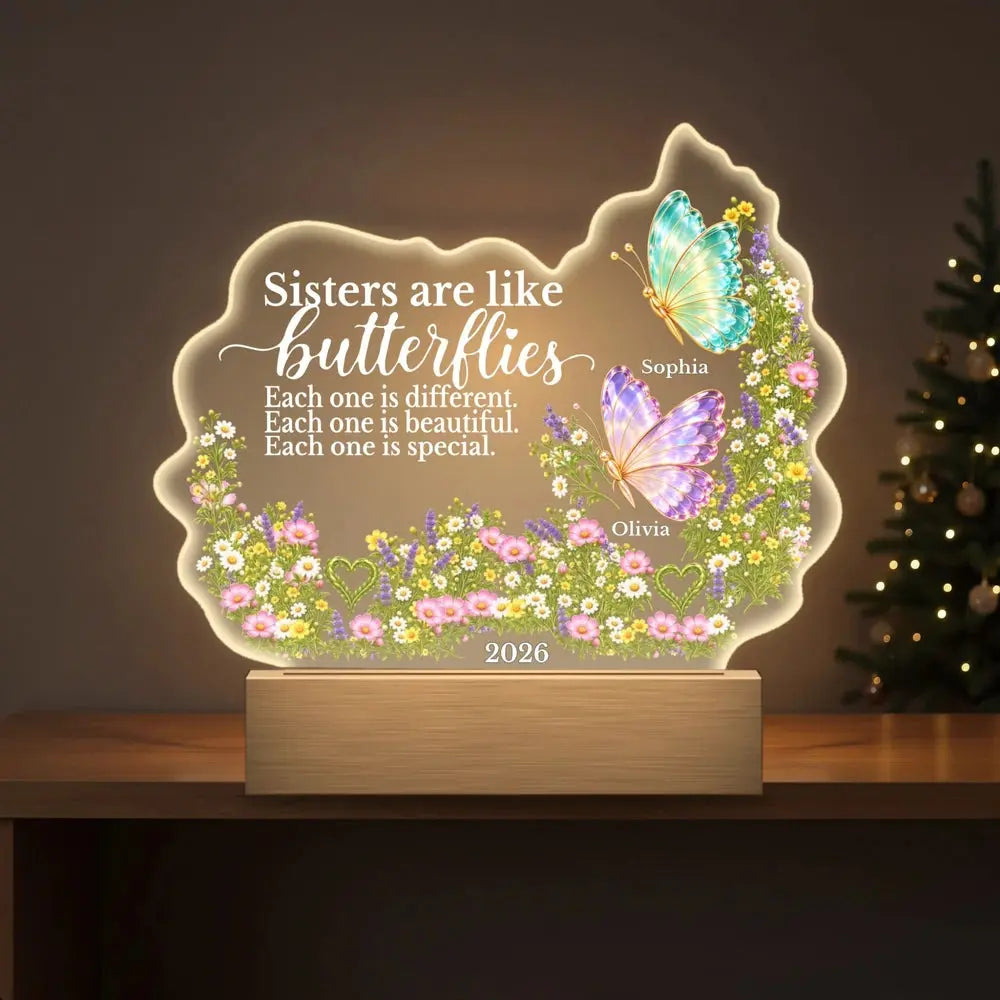 Personalized sisters night light on a shelf by the Christmas tree