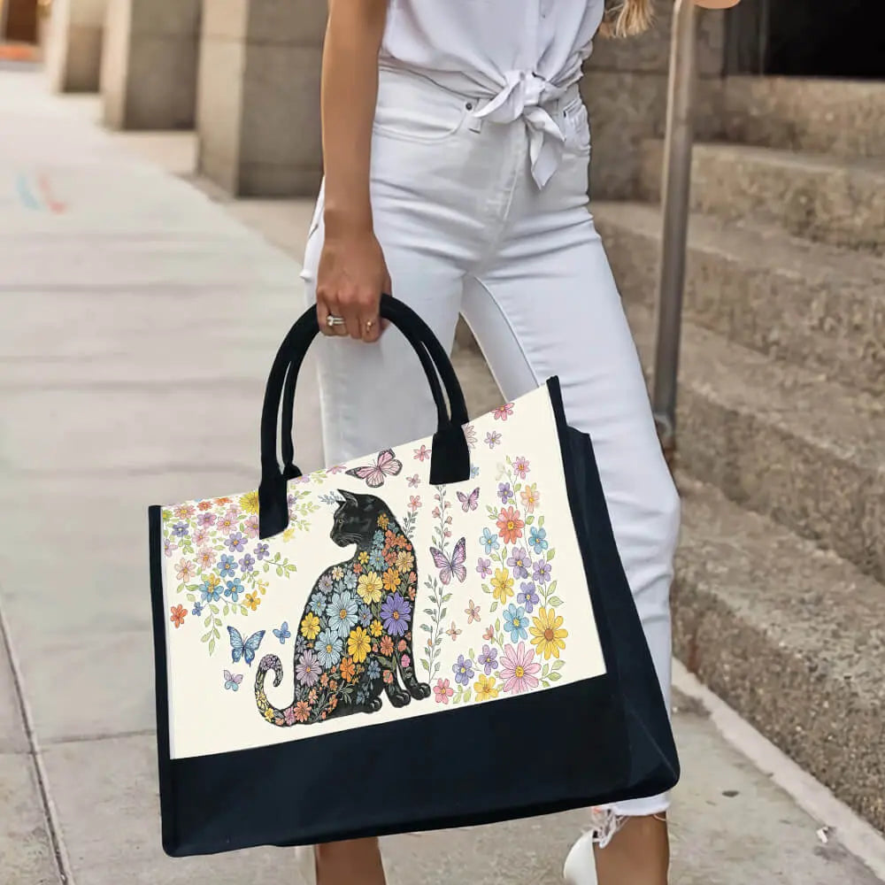 Zoom-in on black cat print and floral art – sustainable canvas cat bag