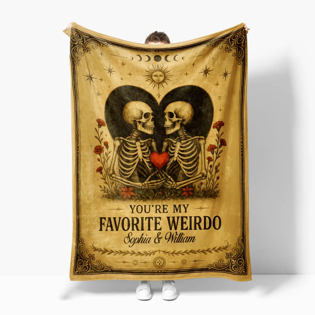 Blanket with skeletons holding hearts and text 'You're my favorite weirdo' on a white background