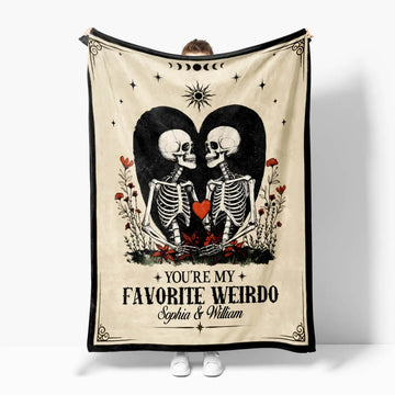 Blanket with skeletons holding hearts and text 'You're my favorite weirdo' on a white background