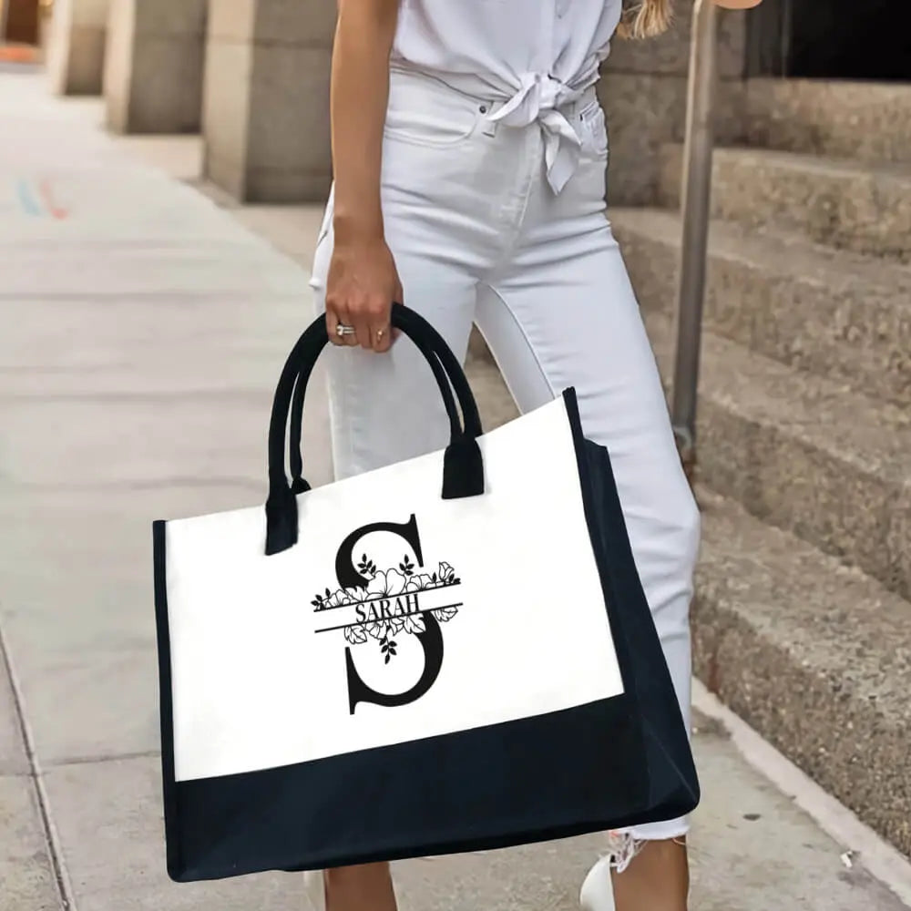 Close-up of embroidery detail on personalized initial canvas tote bag, custom name design
